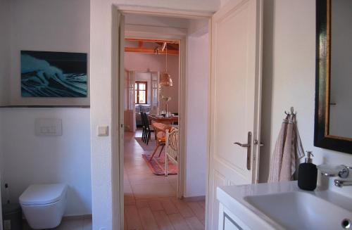 a bathroom with a sink and a toilet in a room at The Art House in Kotrónion