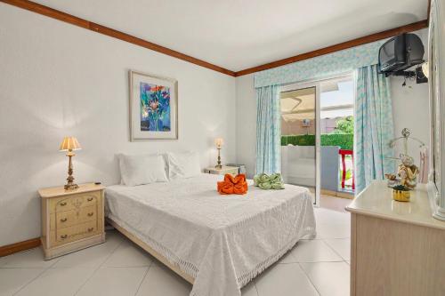 a bedroom with a bed with an orange bow on it at T2 Tivoli in Vilamoura
