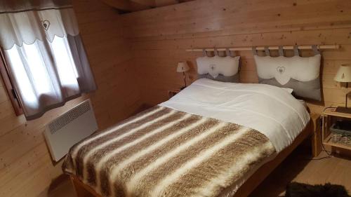 a bedroom with a bed in a wooden room at Can PUGAT in Bolquere Pyrenees 2000