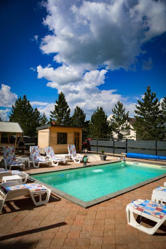 a swimming pool with lounge chairs and a swimming pool at Natural Dream Blidinje in Rudo Polje