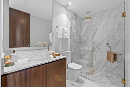 a bathroom with a shower and a toilet and a sink at Beachfront Modern Sanctuary - Bolongo in Higuera Blanca