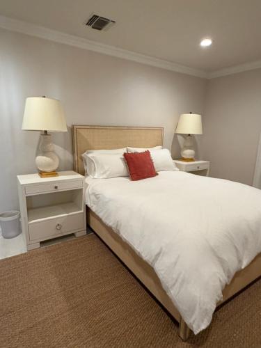 a bedroom with a bed with two nightstands and two lamps at Regiane Residence in Wellington