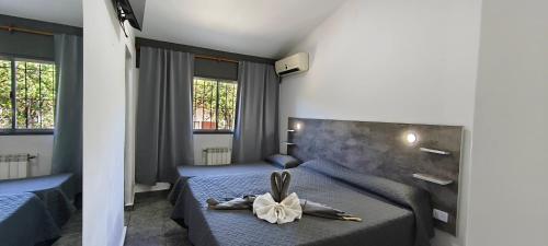 a bedroom with two beds with a flower on it at new bv carlos paz in Villa Carlos Paz
