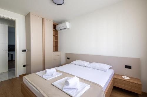 a bedroom with a bed with two towels on it at Villa Sunset Mostar in Mostar