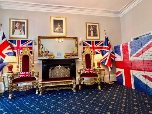 a room with flags on the walls and a fireplace at Jubilee Hotel Victoria in London