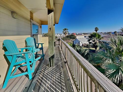 two blue chairs sitting on the porch of a house at Baja Breeze in Port Aransas