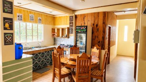 a kitchen and dining room with a wooden table at 3 Mins Drive to Marlboro Hills - Sagada Dad's Homestay in Sagada