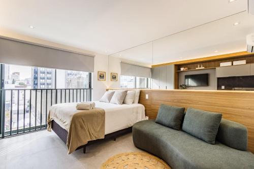 a bedroom with a bed and a couch at GO 24 by My Way in Porto Alegre