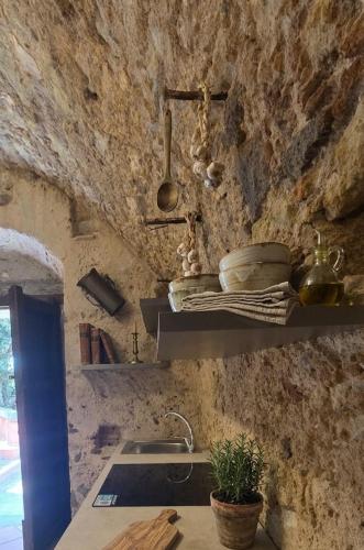a stone kitchen with a sink and a counter top at Residenza La Vigna in Parghelia