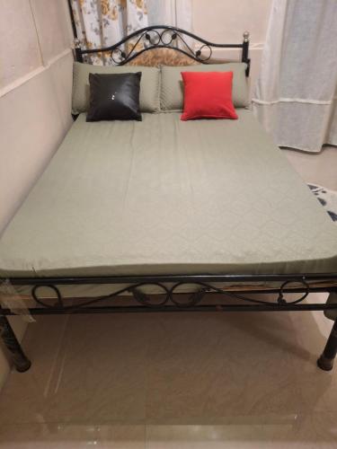 a bed with two pillows on top of it at GD's Homestay in Shillong