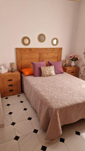 a bedroom with a large bed with pillows on it at Casas Hoya Limpia- Sólo Adultos in Santa Cruz de la Palma