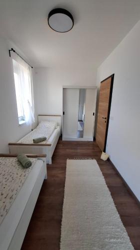 a room with two beds and a mirror at Mirtusz Apartmanház in Balatongyörök