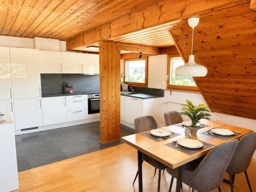 a kitchen and dining room with a table and chairs at Ferienwohnung Saarburg in Saarburg