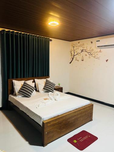 a bedroom with a bed with a green curtain at Airport Kiyas Transit Villa Free Airport Pickup or Drop in Katunayaka