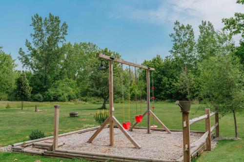 a playground with a swing set in a park at Family Friendly Getaway with Fire Pit & Swing Set in Geneva