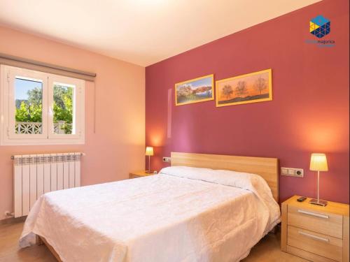 a bedroom with a large bed and a window at Casa Bon Nadal in Llucmajor