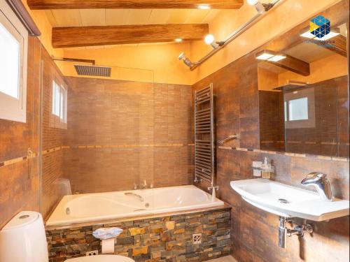 a bathroom with a tub and a sink and a toilet at Casa Bon Nadal in Llucmajor