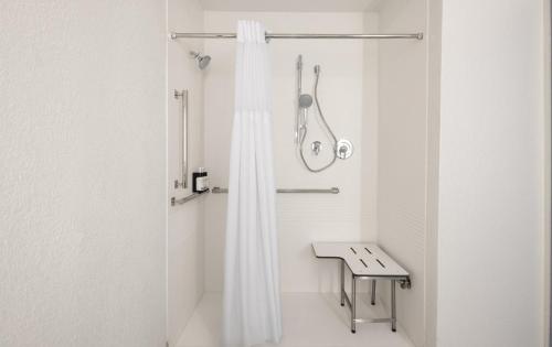 a bathroom with a shower with a shower curtain at Garner Hotel Brockton - Boston by IHG in Brockton