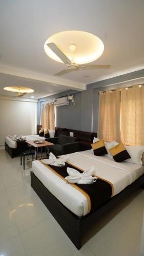 a bedroom with a large bed and a living room at V-Suites in Bangalore