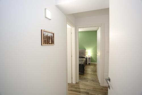 a corridor of a room with a bed and a door at Casa Bea 3 in Castione della Presolana
