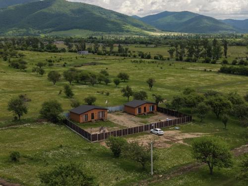 an aerial view of a house in a field at Tianeti Apple Cottages in Churchelaurebi