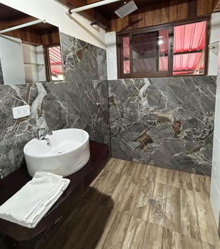 a bathroom with a sink and a mirror at Casa vacacional Tena Archidona in Tena