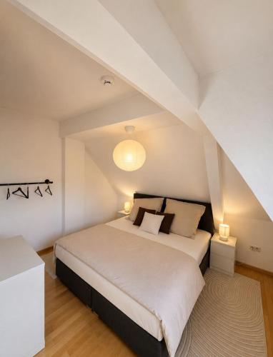 a bedroom with a large white bed in a attic at Ferienwohnung Saarburg in Saarburg