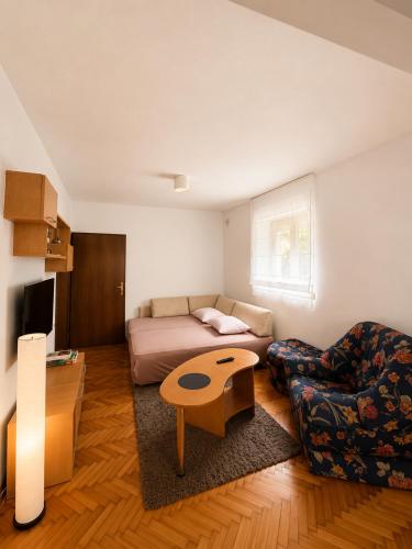 a living room with a couch and a table at Garden Oasis Apartment in Veles