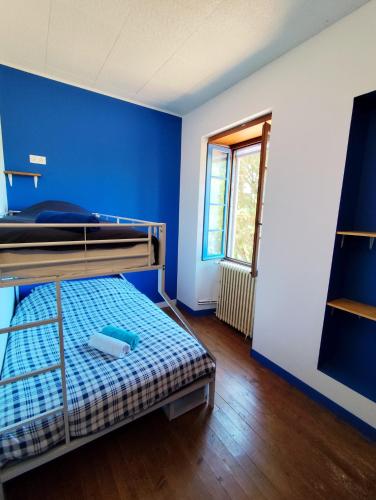 a room with two bunk beds and a blue wall at La Pépite in Sénac