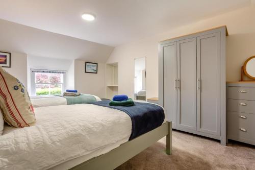 a bedroom with two beds and a window at 3 Bed in Dornoch oc-o44869 in Dornoch