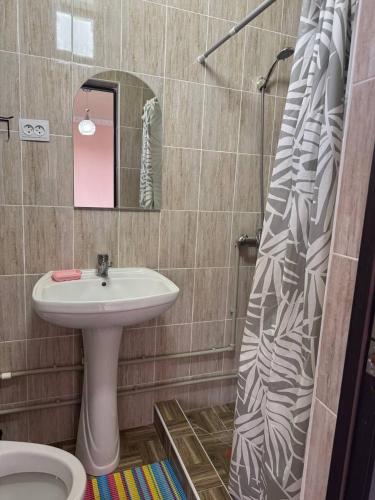 a bathroom with a sink and a toilet and a shower at Бархат плюс in Tossor