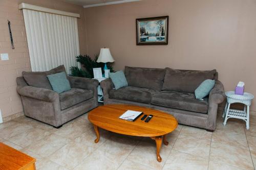 a living room with two couches and a coffee table at NEW Desert Bloom Hideaway in Green Valley