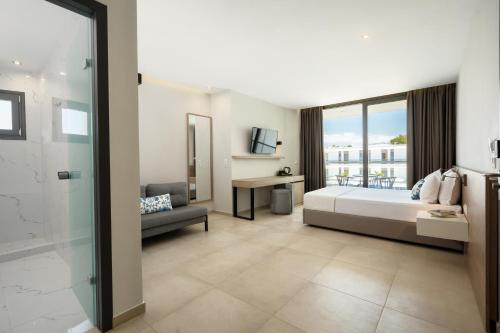 a hotel room with a bed and a window at Ellin Hotel & Spa in Kallithea Halkidikis