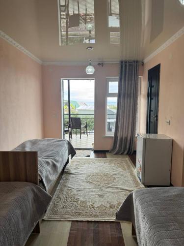 a bedroom with two beds and a view of the ocean at Бархат плюс in Tossor
