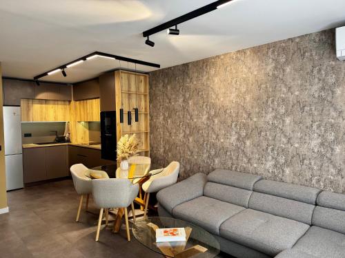 a living room with a couch and a table at Apartment Sonata in Varna City