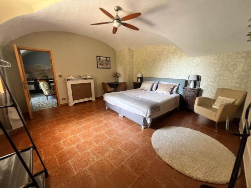 a bedroom with a bed and a ceiling fan at Il Rustico Guesthouse in Lessona