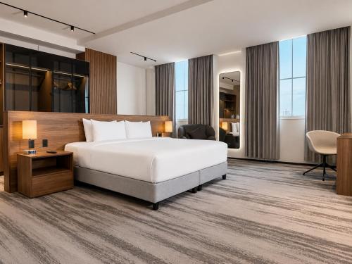 a hotel room with a bed and a desk at Waymore Hotel Spa & Casino in Panama City