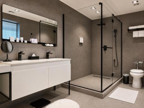 a bathroom with a shower and a sink and a toilet at Waymore Hotel Spa & Casino in Panama City