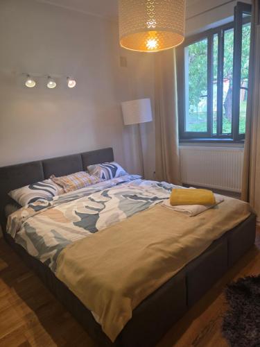 a large bed in a bedroom with a lamp at Dom na Wynajem Gdynia Grabówek in Gdynia