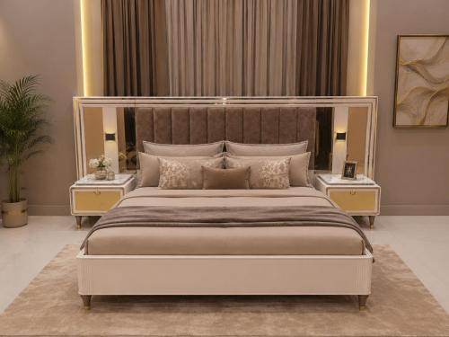 a bedroom with a large bed with two night stands at Guest Villa in Lāsezai