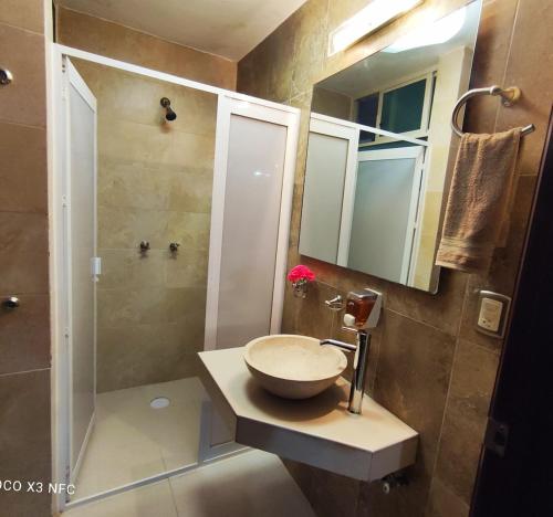 a bathroom with a sink and a shower at Top Pool Condo in Ixtapa's Hotel Area in Ixtapa