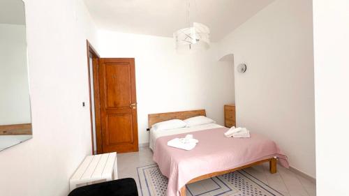 a bedroom with a bed with two towels on it at Acquafredda Ritrovata in Acquafredda