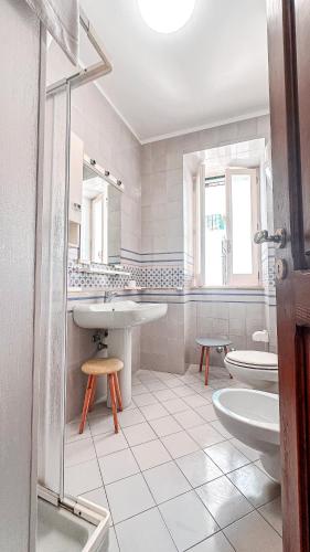 a white bathroom with a sink and a toilet at Acquafredda Ritrovata in Acquafredda