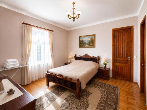 a bedroom with a bed and a table and a window at panorama lasuriashi in Lasuriashi