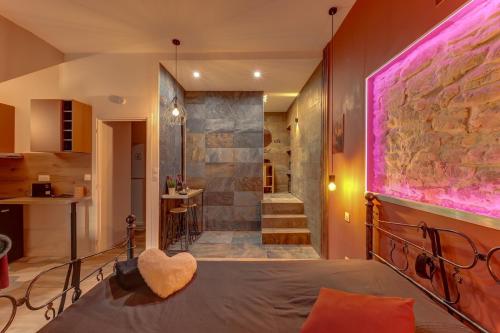 a room with a bed and a walk in shower at Cachette Secrète in Bourgoin