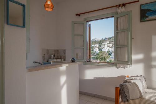 a kitchen with a sink and a window at Marietta Studios Patmos in Skala