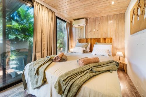 a bedroom with a large bed and a large window at Le Secret Tropical - Parenthèse jacuzzi in Sainte-Marie