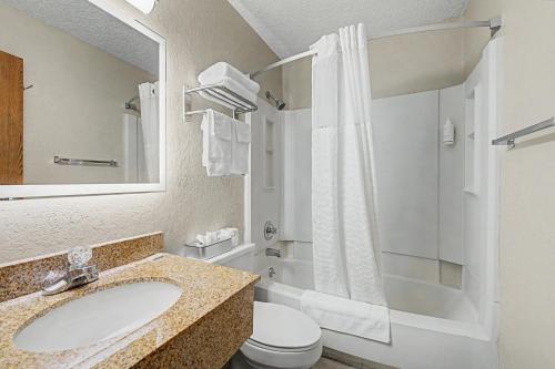 a bathroom with a sink and a toilet and a shower at Super 8 by Wyndham Dubuque in Dubuque