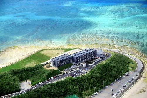 an aerial view of a building next to the ocean at Senagajima Island Resort & Spa in Tomigusuku