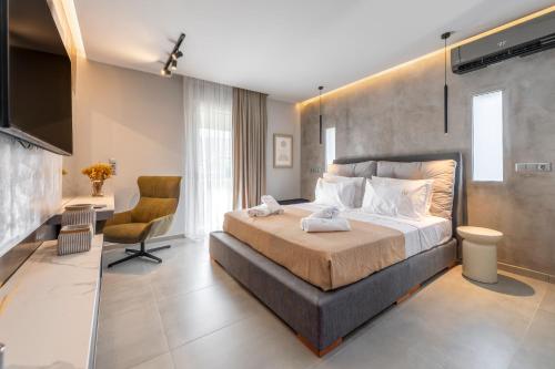 a bedroom with a bed and a desk and a chair at Aeliah in Anavyssos